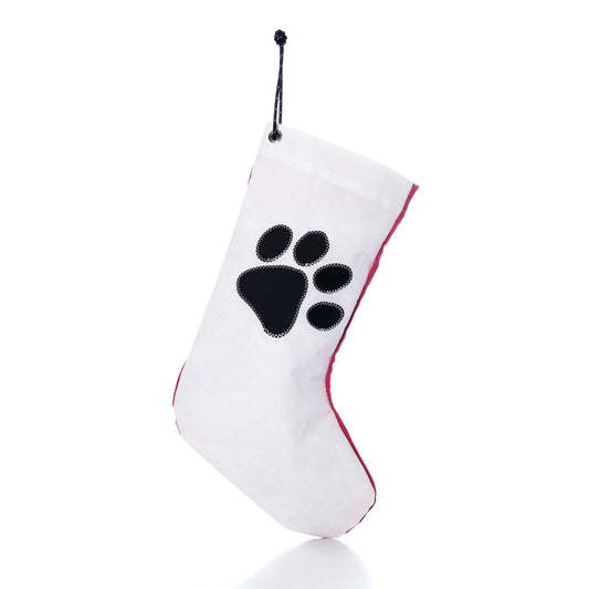 Paw Print Stocking with Personalized Sail Cloth Tag made of white recycled sailcloth with a black paw print design and red trim.