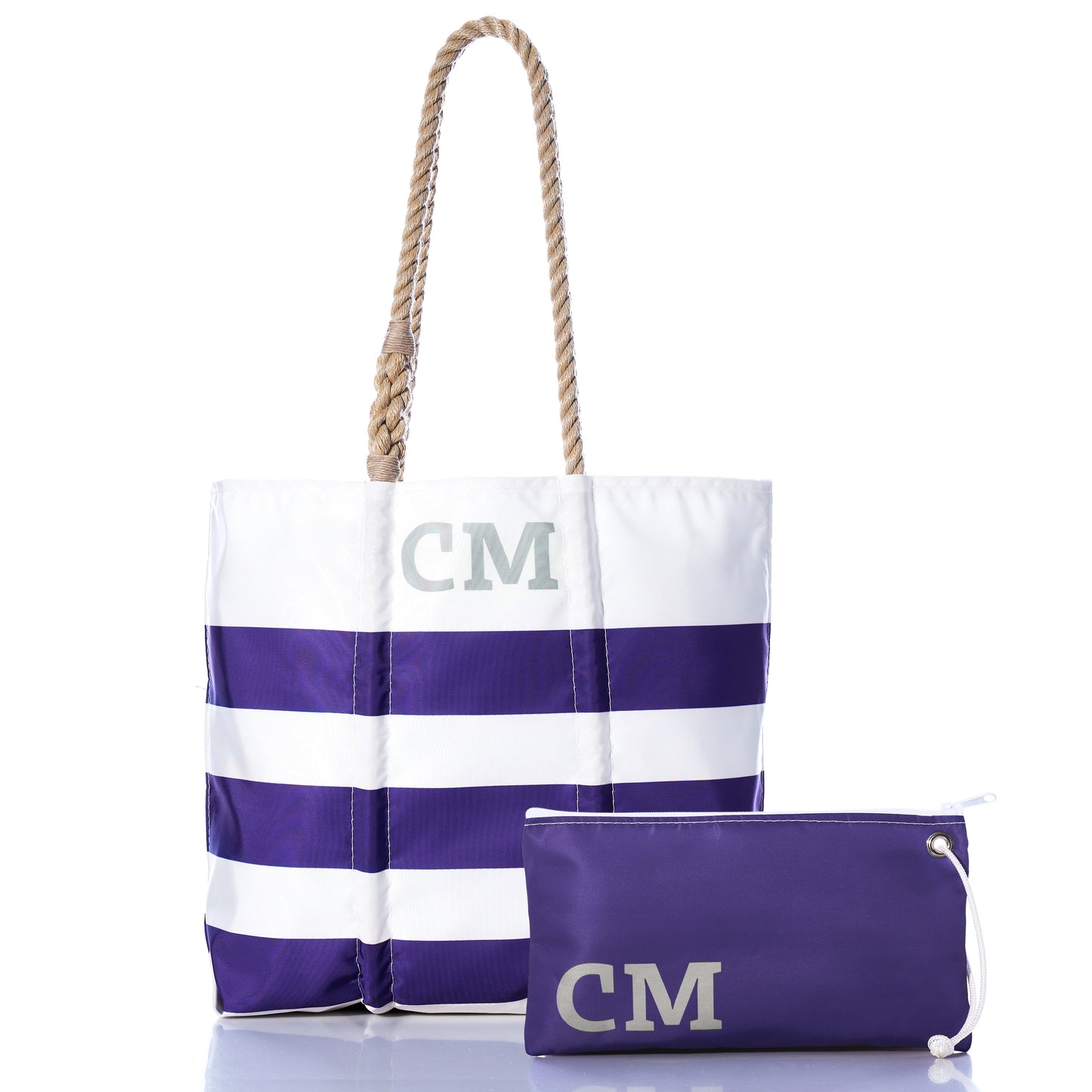 Sea Bags’ Custom Monogram Breton Stripe Medium Tote Large Wristlet Bundle features a white and purple medium tote with rope handles and CM initials, crafted from recycled sailcloth for sustainability, paired with a matching personalized large wristlet showcasing the same distinctive CM monogram.