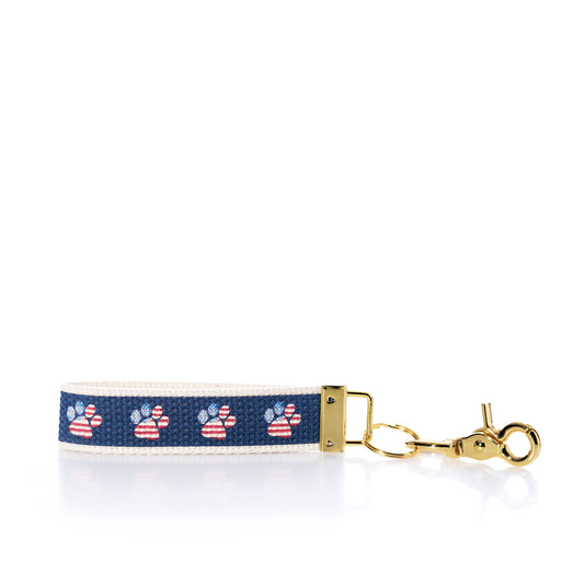 Keychain with paw print pattern on a blue background