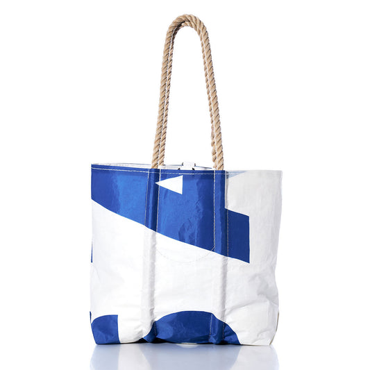 Introducing the Sea Bags Vintage USA Medium Tote—a handmade bag crafted in Maine from durable sailcloth, featuring bold blue and white geometric patterns and two sturdy rope handles. This timeless tote embodies vintage American charm and is presented on a clean, white background. by Sea Bags
