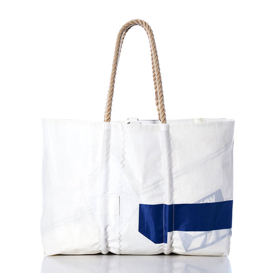 The Sea Bags Vintage 541 Large Tote, displayed on a plain white background, features hand-spliced rope handles, visible stitching, and a striking blue diagonal stripe. Handcrafted in Maine, this spacious white tote captures classic nautical style reminiscent of a vintage sail bag. by Sea Bags