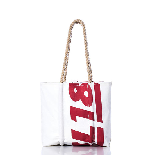 Sea Bags Vintage Ideal 18 Handbag—a white tote featuring thick hemp rope handles and bold red sail insignias printed vertically on the front, photographed against a white background. by Sea Bags