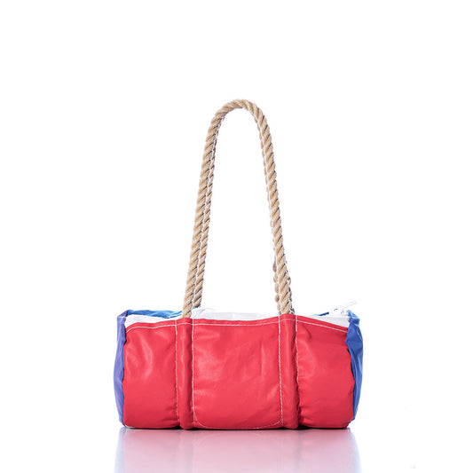 The Sea Bags Vintage Red and Blue Baguette Bag, crafted from recycled sails with hand-spliced hemp rope handles, is displayed on a white background. by Sea Bags