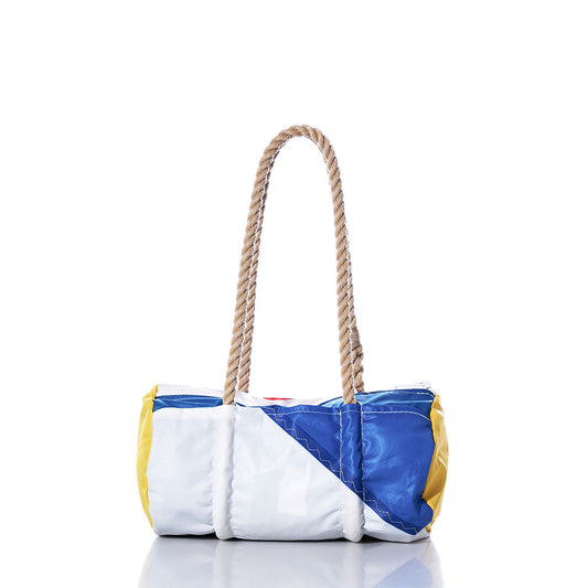 The Sea Bags Vintage Multicolor Baguette Bag is a small rectangular handbag made from a patchwork of recycled blue, white, and yellow sails, featuring two thick hand-spliced hemp rope handles, shown on a white background. by Sea Bags