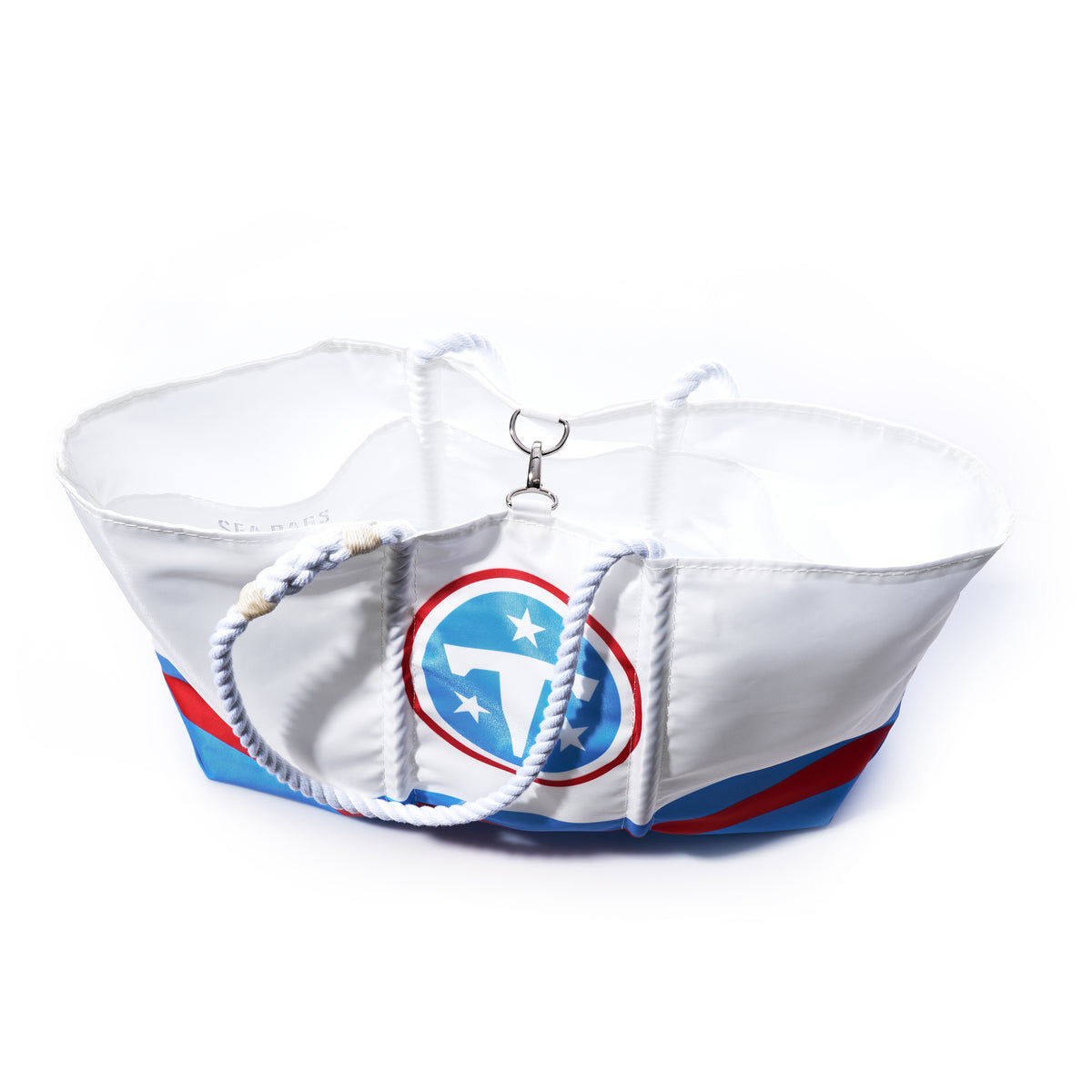 Introducing the Tennessee Titans Tailgate Tote by Sea Bags—a large white tote bag crafted from durable recycled sail cloth for style and sustainability. Featuring navy blue rope handles, the official Tennessee Titans logo, and a spacious off-white interior, this NFL logo bag is perfect for any Titans fan. Displayed against a plain white background. by Sea Bags