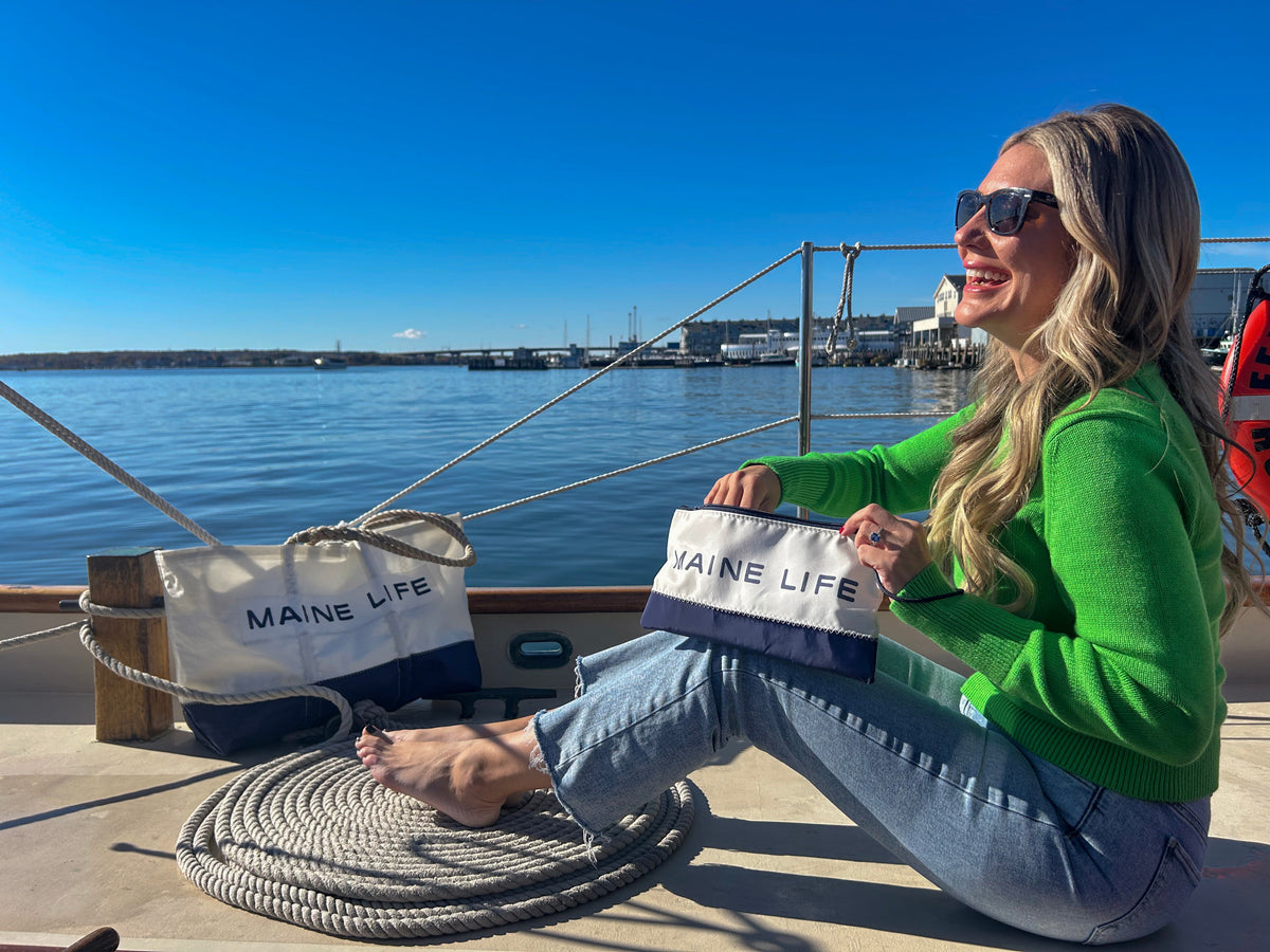 Erin Ovalle of Maine Life TV on a dock showing the new Sea Bags partnership line