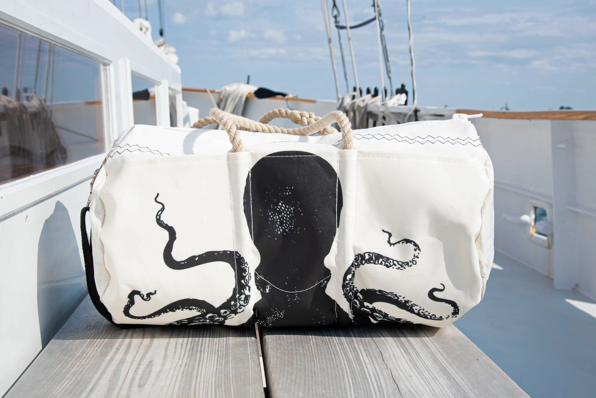 recycled sail cloth duffel bag with a cool octopus, sitting on a boat