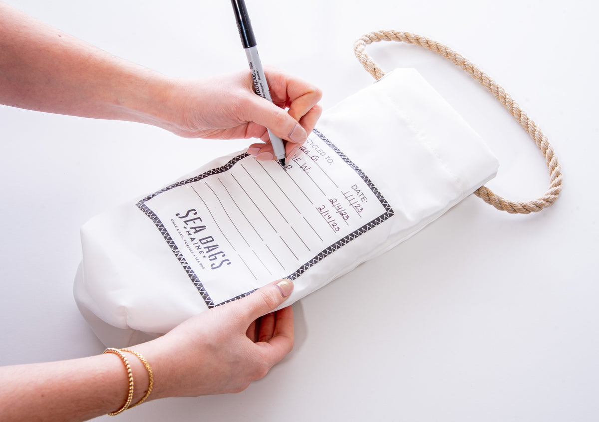 Re-usable wine tote bag with label on back for logging each handoff to friends