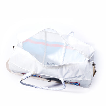 A Sea Bags Tennessee Titans Duffel, made from recycled sail cloth, features rope handles and a beige shoulder strap and is displayed unzipped to reveal its empty interior.