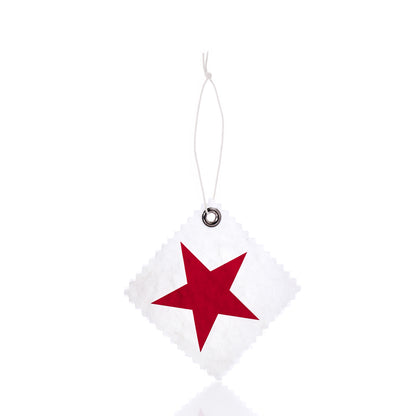 The Sea Bags Star Sail Cloth Gift Tag features a white, square-shaped design crafted from recycled sailcloth, with a bold red star at its center. It includes a metal-reinforced hole and string for hanging, shown against a white background. by Sea Bags