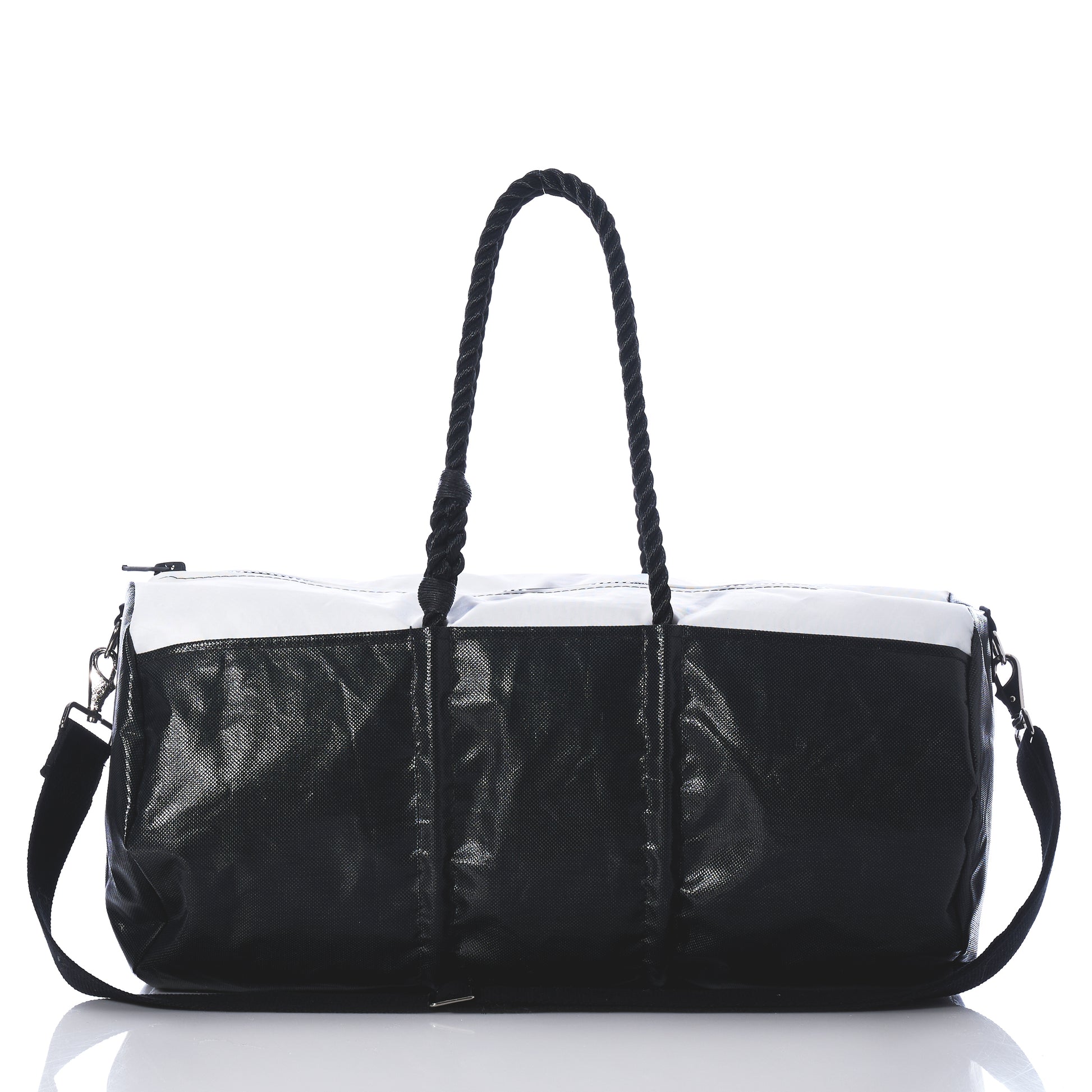 Black and white handbag with braided handle on a white background