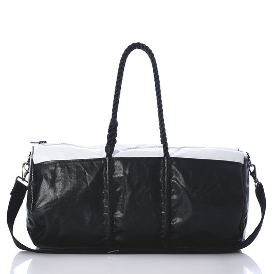 Black and white handbag with braided handle on a white background