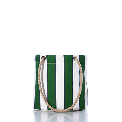 The Preppy Stripe Essential Handbag by Sea Bags, crafted from recycled sailcloth and featuring green and white vertical stripes with two rope handles, stands upright on a white reflective surface, showcasing its classic collegiate-inspired style. by Sea Bags