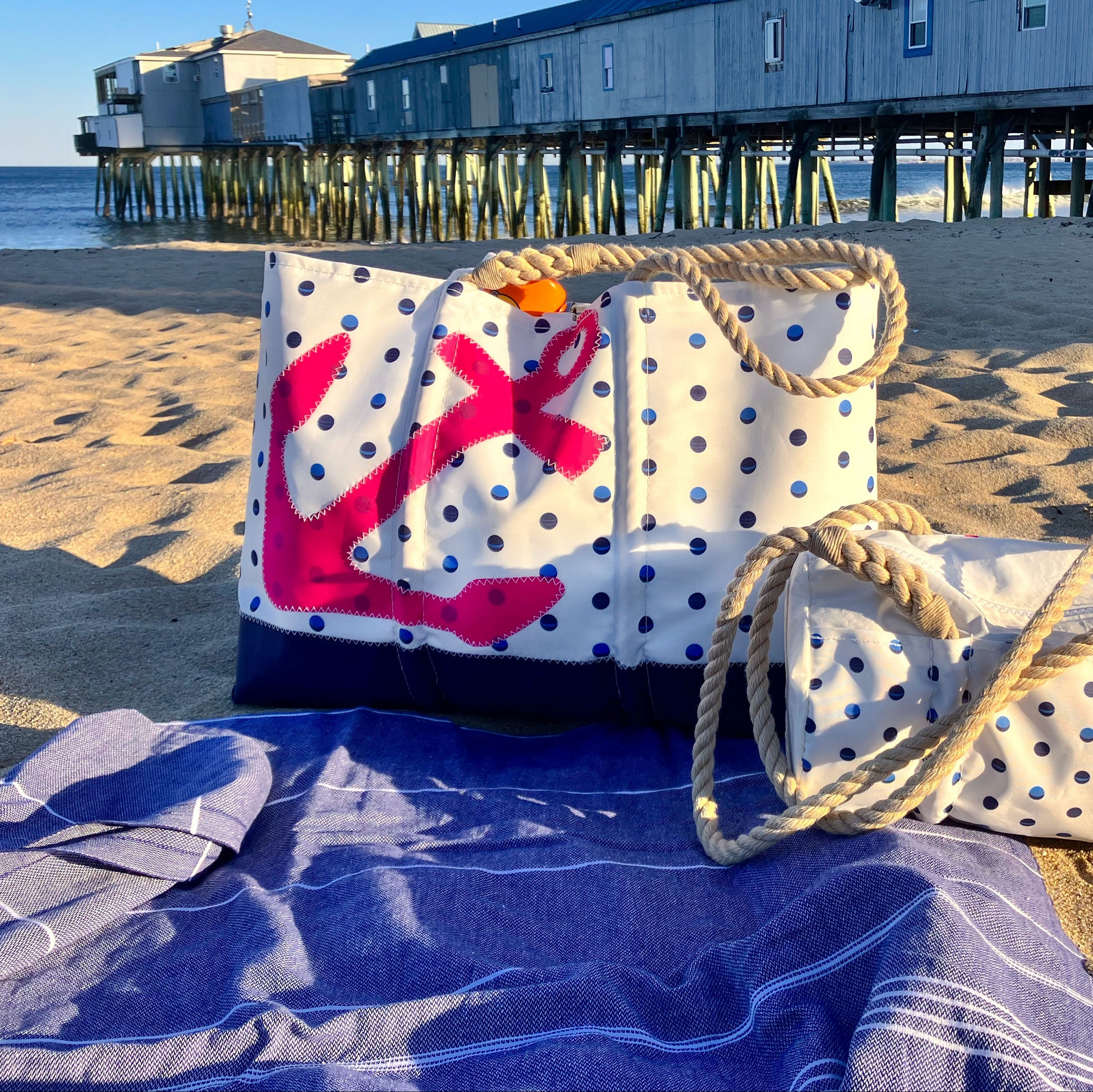 Fuchsia anchor polka dots travel beach bag on sand by the pier 50s retro