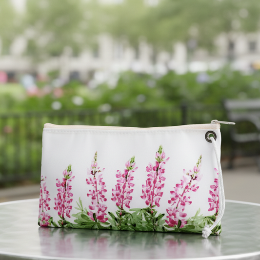 Cure Pink Lupine Wristlet on cafe table by city garden from Sea Bags
