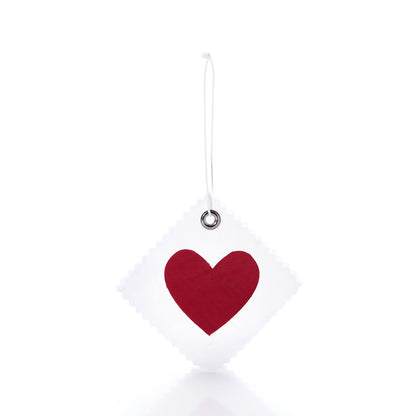 Introducing the Sea Bags Heart Sail Cloth Gift Tag: a square gift tag crafted from recycled white sail cloth, adorned with a red heart at the center. It features a metal-reinforced hole and comes with a white string for hanging, shown here against a plain white background. by Sea Bags