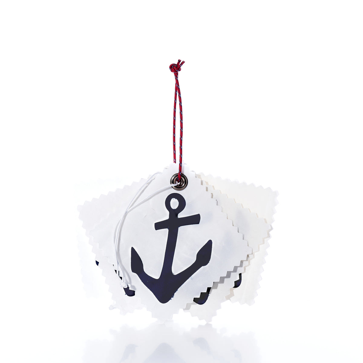 A stack of five square, white fabric Sail Cloth Gift Tag - Pack of 5 - Navy Anchor gift tags with pinked edges, each featuring a black anchor print and strung together with a red and blue cord.