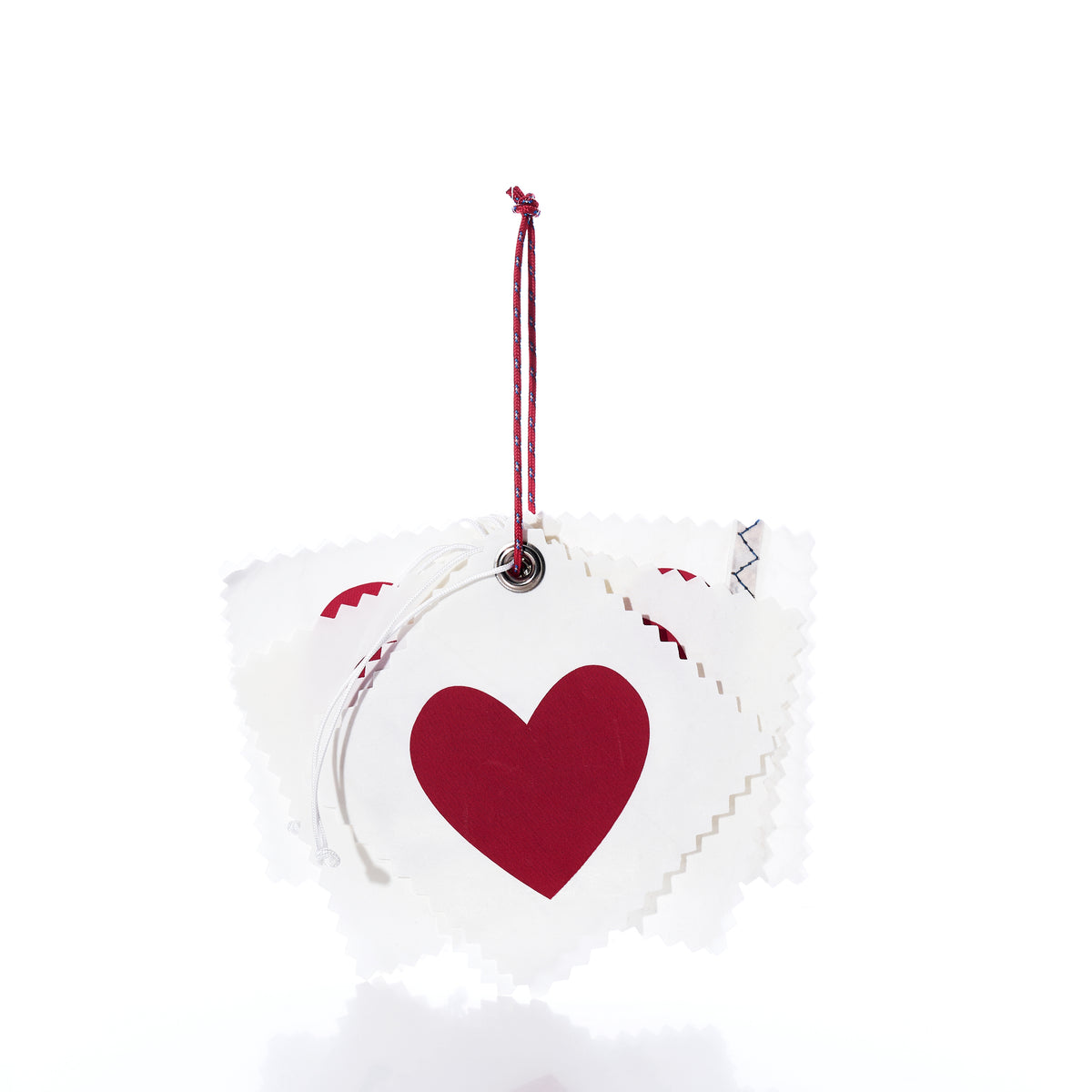 A stack of five heart-shaped Sea Bags Sail Cloth Gift Tag - Pack of 5 - Heart featuring red hearts and red and white cord loops.