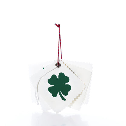 Five square white recycled Sail Cloth Gift Tag - Pack of 5 - Four Leaf Clover tags with pinked edges, printed with green clovers and strung on a thin, multicolored cord.