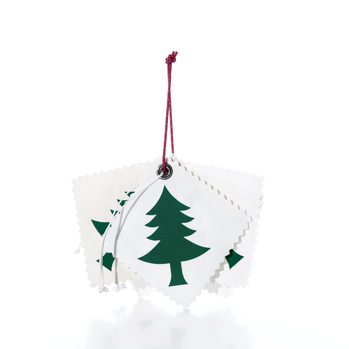 A pack of 5 Sail Cloth Gift Tag - Pine Tree, featuring five square recycled sail tags with pinked edges, green pine tree prints, and string for hanging.