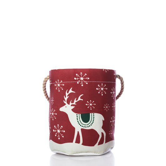 Scandinavian Holiday Bucket Bag in recycled sailcloth featuring a red base, white reindeer, green saddle, Scandinavian geometry snowflake pattern, and rope handles.