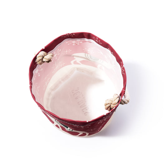 Scandinavian Holiday Bucket Bag made of recycled sailcloth, featuring a round shape, red rim, white geometric snowflake pattern, and rope handles.