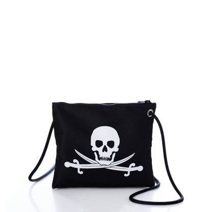 Sea Bags Jolly Roger Slim Crossbody—a black zippered pouch made from recycled sailcloth, featuring a rope strap and a bold white skull and crossed swords graphic on the front, shown against a white background. by Sea Bags