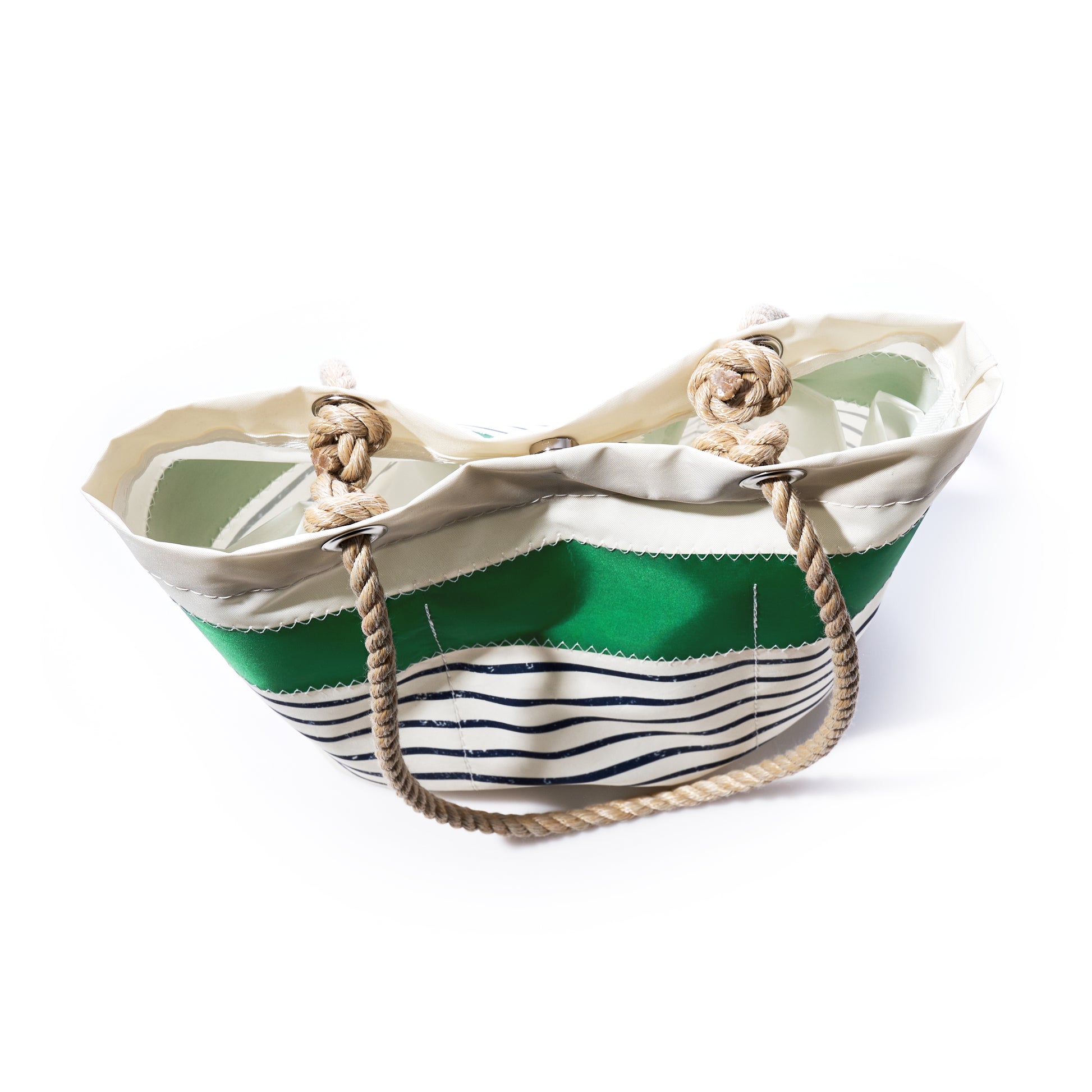 The Sea Bags Green-on-Navy Mariner Stripe Essential Handbag features green and white stripes with rope handles and nautical knot accents, inspired by classic recycled sail cloth handbags, and is photographed on a white background.