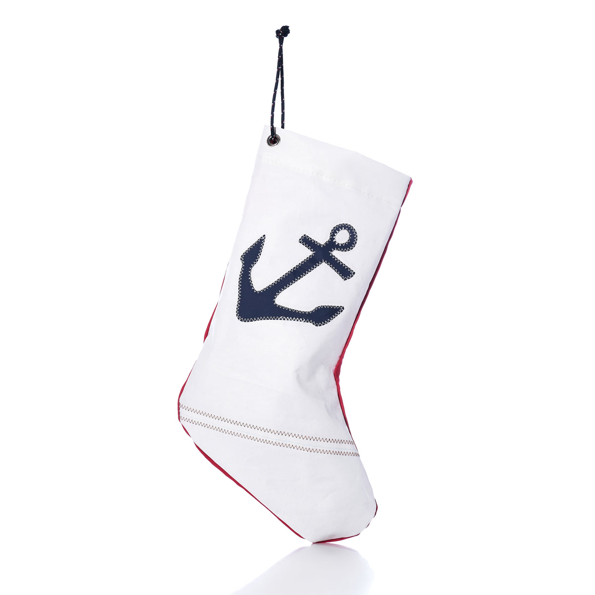 Navy Anchor Stocking made of white sail-cloth with a navy blue anchor print, red trim, and a black hanging cord.