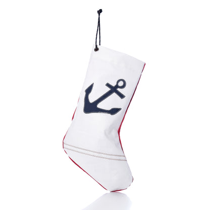 Navy Anchor Stocking made of white sail-cloth with a navy blue anchor print, red trim, and a black hanging cord.