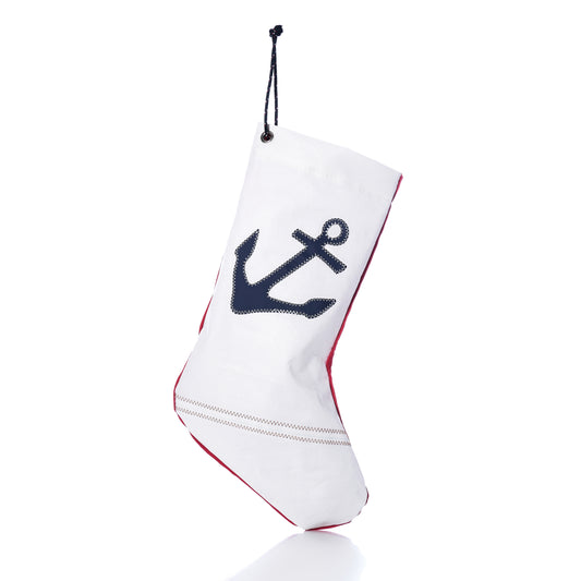 Navy Anchor Stocking made of white sail-cloth with a navy blue anchor print, red trim, and a black hanging cord.