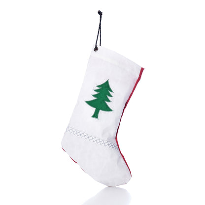 The Sea Bags Pine Tree Stocking, crafted from recycled sailcloth and featuring a green tree design, hangs by a black string against a white background.