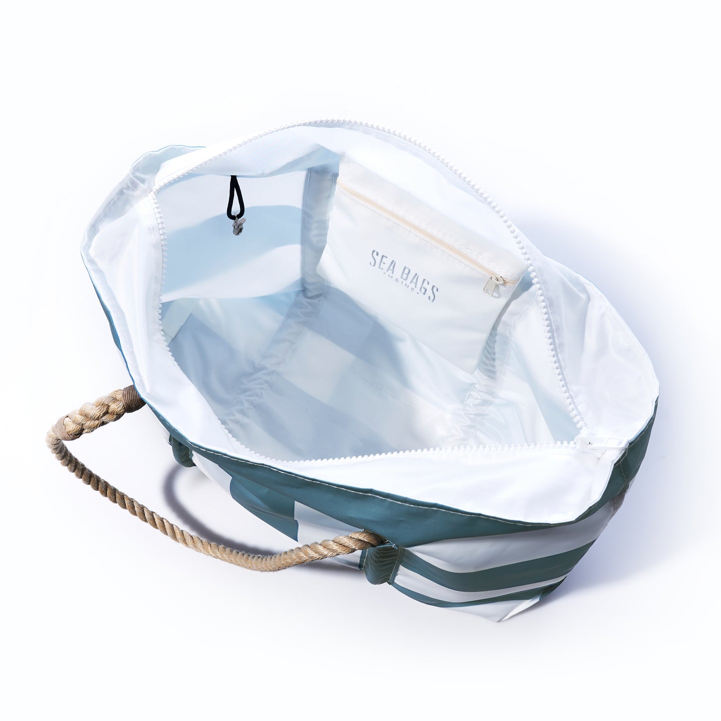Introducing the Denim Blue Trolley Sleeve Travel Pier Tote from Sea Bags: crafted from open striped recycled sailcloth with sturdy rope handles, a white interior featuring a zippered pocket labeled SEA BASS, and a black hook attached inside—perfect for travel with its convenient trolley sleeve that makes airport transit effortless. by Sea Bags