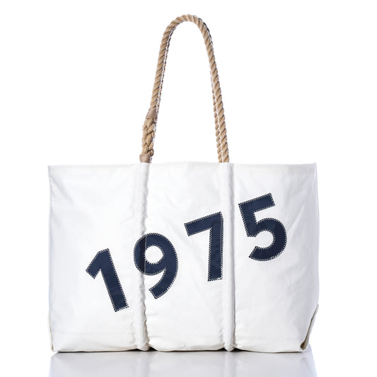 Introducing the Sea Bags Custom Year Large Tote—a spacious white bag with durable rope handles and your chosen year, such as “1975”, boldly stitched in black on the front against a crisp white backdrop.
