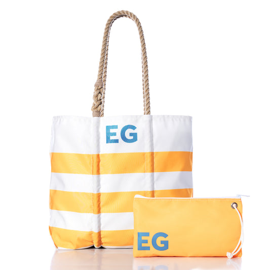Sea Bags Custom Monogram Breton Stripe Medium Tote  Large Wristlet Bundle featuring a white and yellow striped tote bag with rope handles, personalized with blue EG initials and crafted from recycled sailcloth, paired with a matching large yellow wristlet displaying the same initials.