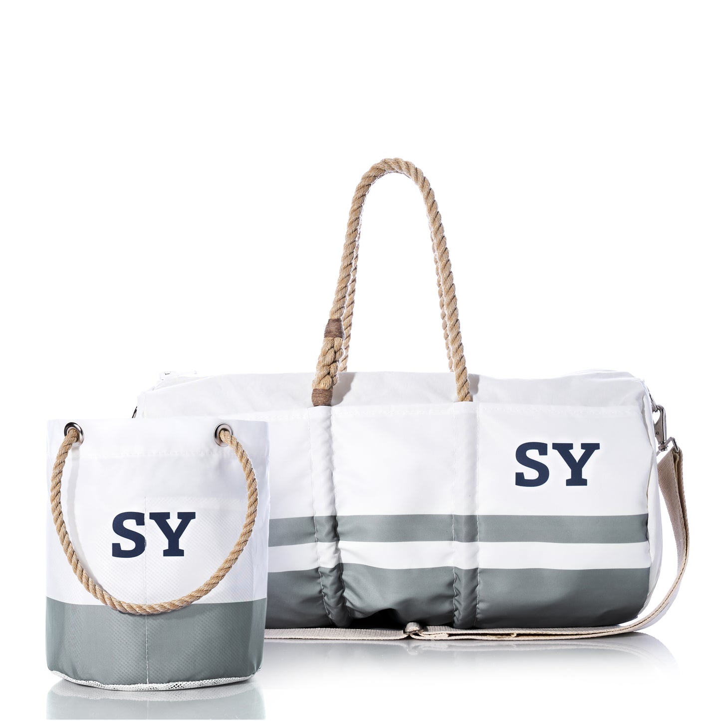 Custom Monogram Breton Stripe Duffel and Bucket Bundle from Sea Bags features a spacious tote and a compact bucket bag, both crafted from recycled sailcloth with white and gray stripes, rope handles, and your choice of monogram displayed on the front against a white background.
