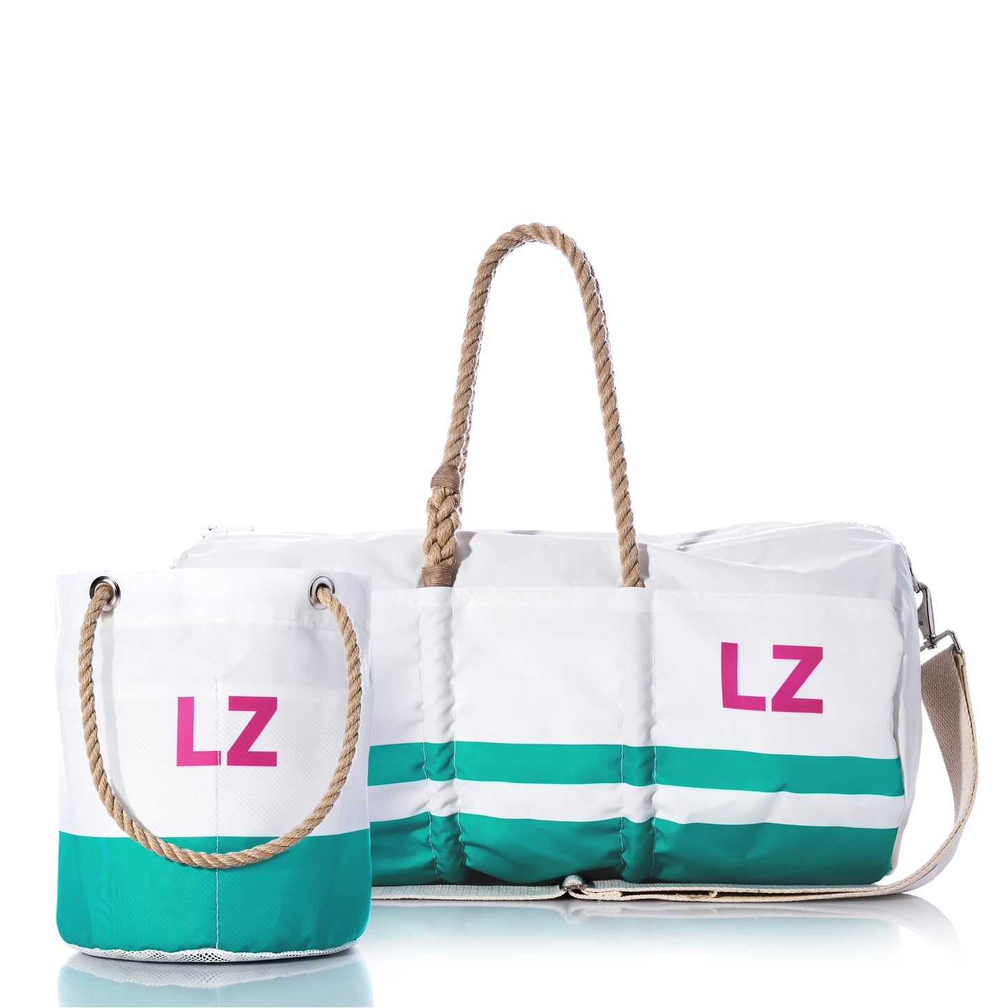 The Sea Bags Custom Monogram Breton Stripe Duffel  Bucket Bundle features two white recycled sailcloth bags with green stripes and tan rope handles, each adorned with pink “LZ” monogramming—offering timeless style and eco-friendly craftsmanship against a clean white background.