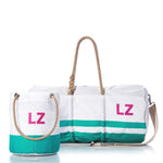 The Sea Bags Custom Monogram Breton Stripe Duffel  Bucket Bundle features two white recycled sailcloth bags with green stripes and tan rope handles, each adorned with pink “LZ” monogramming—offering timeless style and eco-friendly craftsmanship against a clean white background.