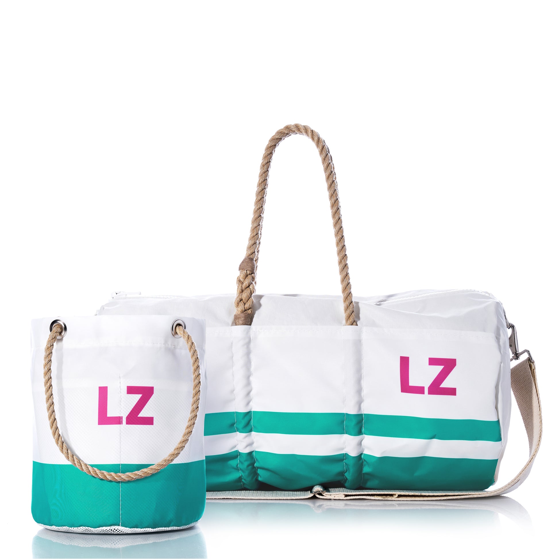 The Sea Bags Custom Monogram Breton Stripe Duffel  Bucket Bundle features two white recycled sailcloth bags with green stripes and tan rope handles, each adorned with pink “LZ” monogramming—offering timeless style and eco-friendly craftsmanship against a clean white background.
