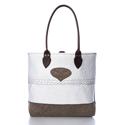 Heritage Ticonderoga Medium Tote made from white vintage sail cloth, featuring brown leather handles, a brown base, and a brown leather patch with an eagle emblem on the front.