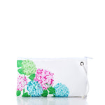 Sea Bags 2026 Hope In Bloom Large Wristlet in white sustainable sailcloth with a pattern of green, pink, and blue hydrangea flowers and leaves.