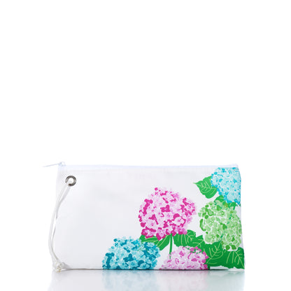 White zippered 2026 Hope In Bloom Large Wristlet made of sailcloth with a print of pink, blue, and green hydrangea flowers.