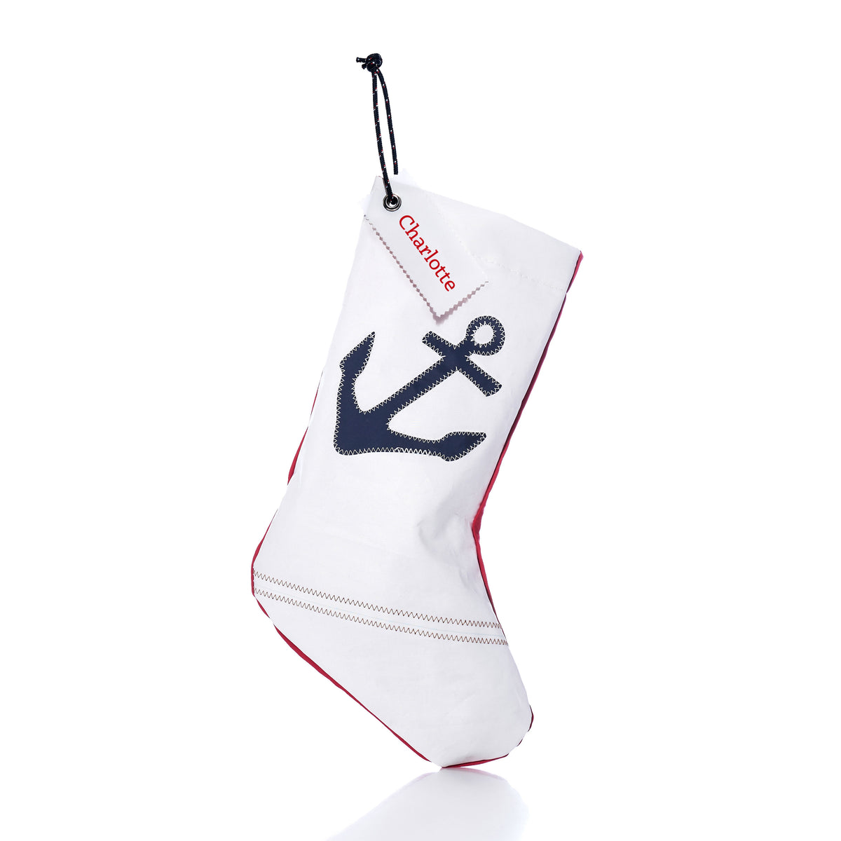Navy Anchor Stocking with Personalized Sail Cloth Tag featuring a white eco-friendly sail-cloth design, a dark blue anchor, and a custom name tag reading “Charlotte.”