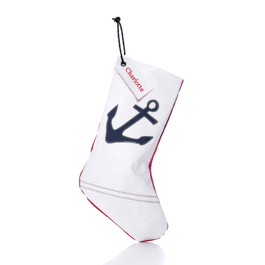 Navy Anchor Stocking with Personalized Sail Cloth Tag featuring a white eco-friendly sail-cloth design, a dark blue anchor, and a custom name tag reading “Charlotte.”