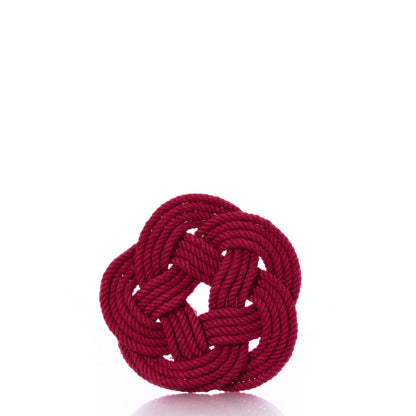 A set of four Mystic Knotwork Nautical Sailor Knot Coasters in red, crafted from rope and tied into decorative circular knots reminiscent of classic nautical designs, is displayed against a plain white background.