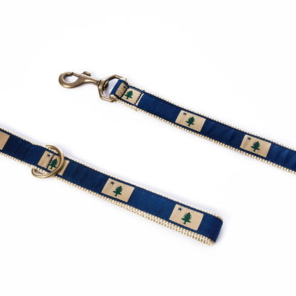 Belted Cow Maine Flag Dog Leash patterned with a green pine tree and blue star, finished with a metal swivel bolt snap and D-ring.
