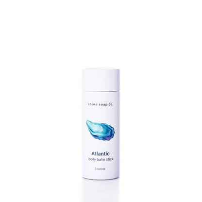 A 2-ounce white tube of Shore Soap Co. Atlantic Eco-Friendly Body Balm Stick stands upright on a white background, providing concentrated moisture and hydration for dry skin.