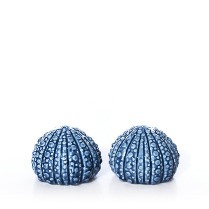 Two blue, textured ceramic Batela - Sea Urchin Salt  Pepper Shaker Set pieces for coastal table decor.