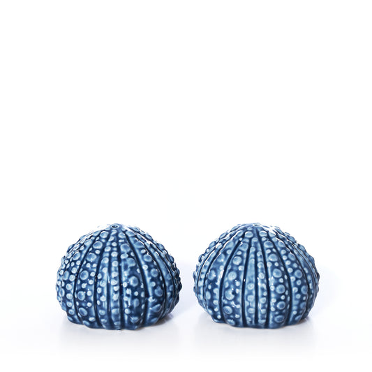 Two blue, textured ceramic Batela - Sea Urchin Salt  Pepper Shaker Set pieces for coastal table decor.
