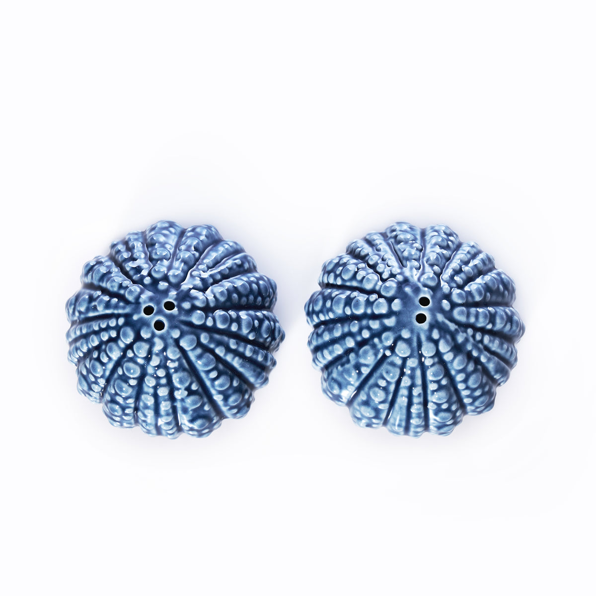 Top-down view of two blue ceramic Batela - Sea Urchin Salt  Pepper Shaker Set pieces, perfect for coastal table decor.